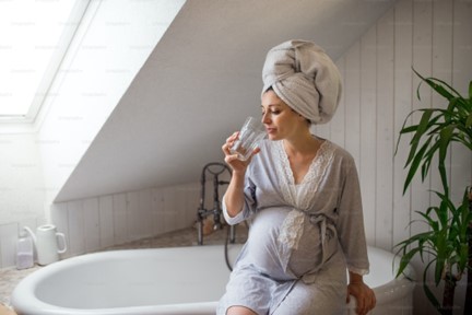 Pregnant woman by the bath tub